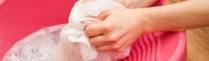 Hand washing silk bed sheets.
