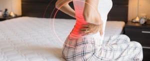 A person on a spring mattress with back pain.