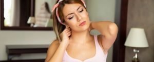 Woman with Neck Pain from Sleeping on a Bad Mattress.