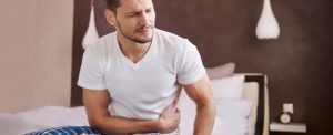 Man With Stomach Ulcer Trying to Sleep.