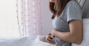 Woman Sleeping With Stomach Pain.