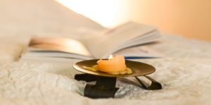 Unsafe Candle on Bed.