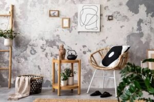 Minimalist bedroom corner featuring natural wood furniture, a woven accent chair, neutral décor, and textured walls with earthy tones.