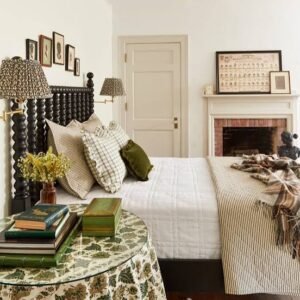 Cozy guest bedroom with layered bedding, patterned throw blanket, decorative pillows, bedside lamps, and classic farmhouse-style décor.